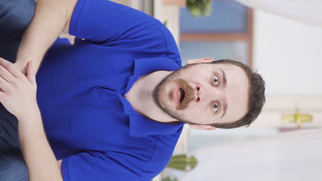 Vertical-video-of-Man-looking-at-camera-confused.